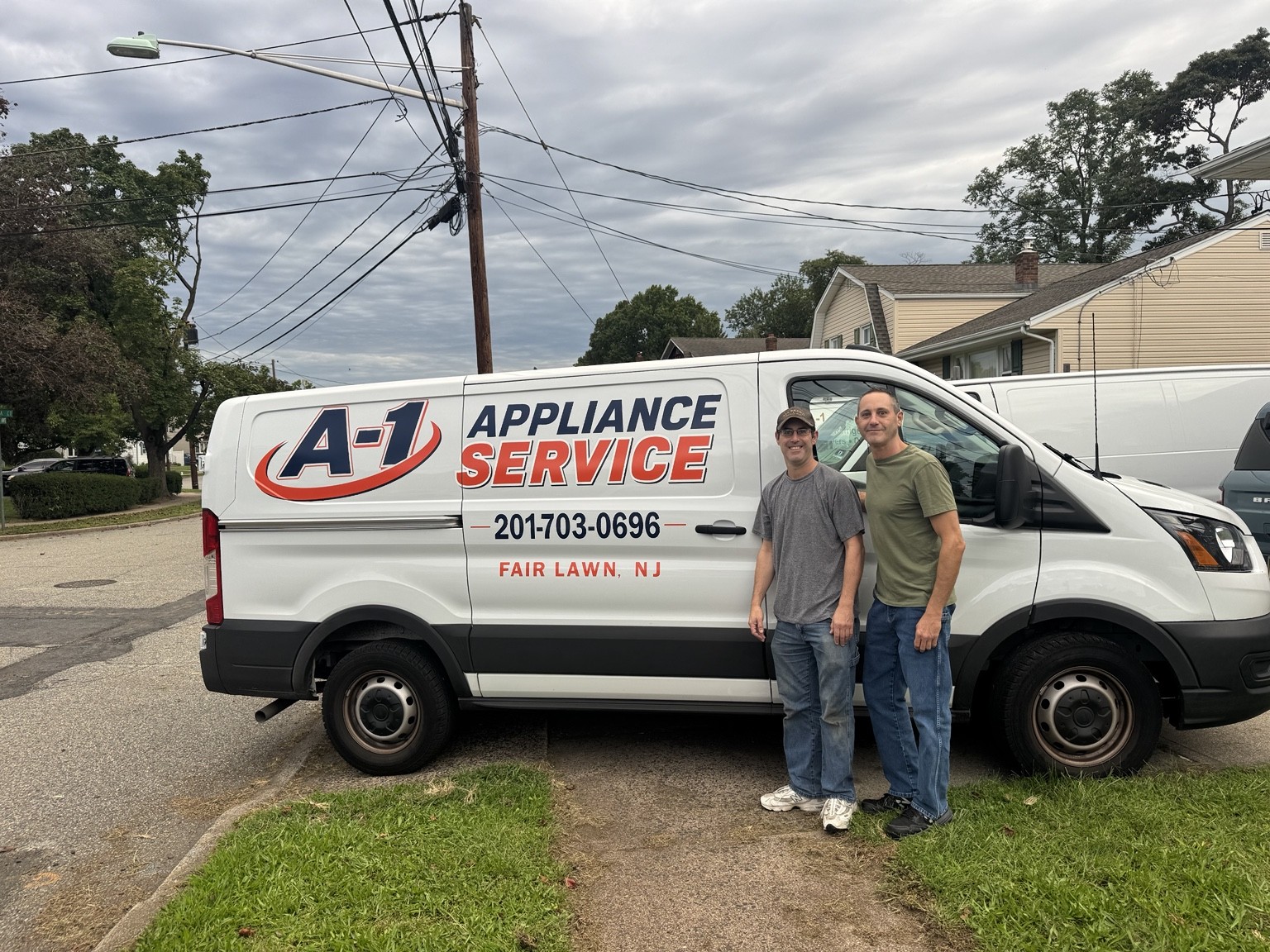 Jeff and Adam standing beside the A-1 Appliance Service van